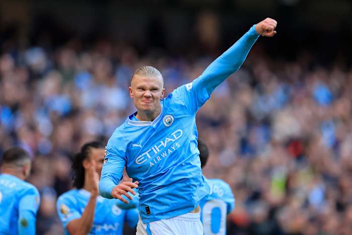 Erling Haaland pictured celebrating after scoring the 50th goal of his Premier League career during a game between Manchester City and Liverpool in November 2023